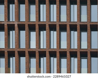 Texture, design and right geometry of new modern residetial building exterior in the city Moscow in spring day. Modern construction. Close up photography. Brown color in the design