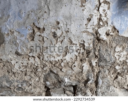 texture of a deteriorated old wall, with a partially repaired spalling, grunge cracked concrete wall, horizontal