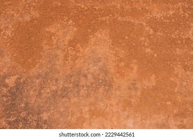Texture of dirt floor with some cracks, used on clay tennis courts. Brick dust.