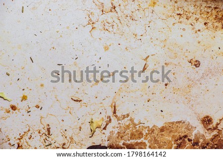 Texture of dirty stains and grease on white stove. Dried stains of fat on a white background