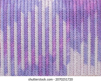 The Texture Of The Embroidered Fabric With A Tapestry Stitch With Purple Yarn. Close-up Of Embroidery On A Plastic Canvas.