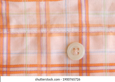 The texture of the fabric with a button for clothes.