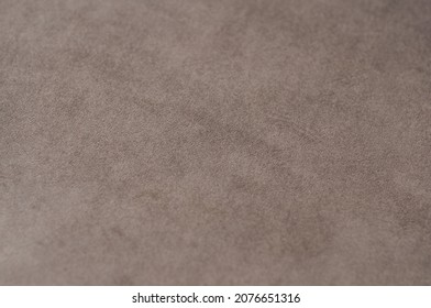 The texture of the fabric is velor beige. Background Velvet upholstery furniture.