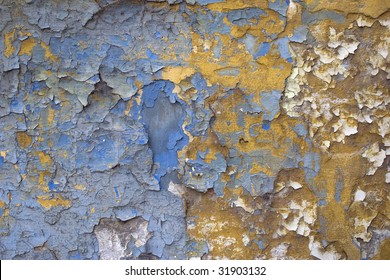 Texture - Flaking off Blue and Yellow from an old wall.