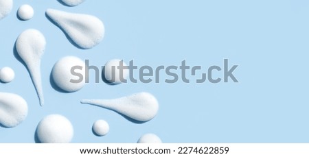 texture foam mousse foam cosmetic smear sample on blue background