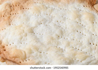 The Texture Of A Fragile, Golden Freshly Baked Cake Crust With Holes From A Fork Close Up 