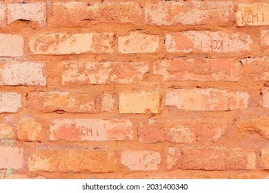 Texture fragment of ancient brick fortress wall surface without plaster closeup. Old brickwork. Red grunge brick wall, abstract background with old vintage style pattern.