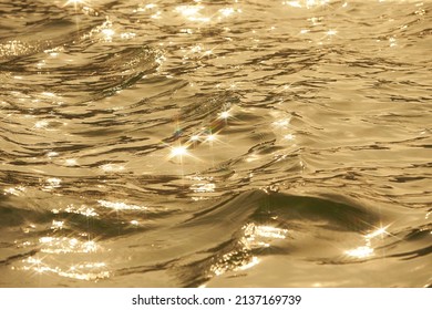 Texture Of Glitter Water And Soft Waves. Sparkling In Water - Background. Sea Water With Sun Glare And Ripple. Powerful And Peaceful Nature Concept.