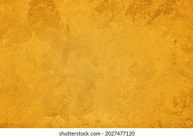 Texture of golden decorative plaster or concrete. Abstract grunge background for design.