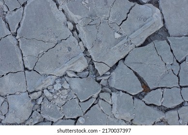 Texture Of Gray Pieces Of Stones With Cracks On The Ground 