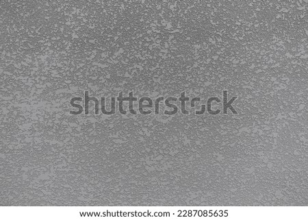 Texture of gray semi-smooth wall with stucco lace finish