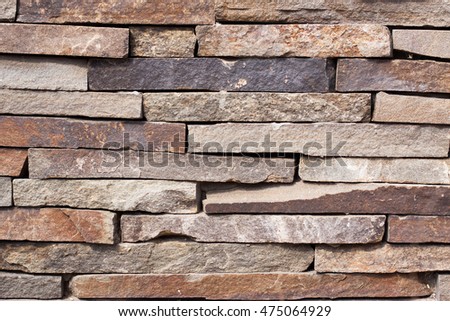 The texture of the gray stonework. The wall built of rectangular stones. Space for text. The concept of reliability, construction, good home, hearth