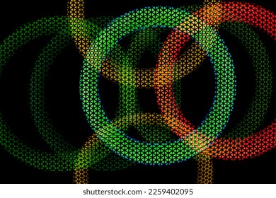 Texture green and red circles in grid on dark background. Glow in dark. Abstract disco background. Colored light. Circles intersect.