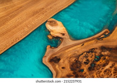 Texture of handmade wooden river table with decorative epoxy blue resin