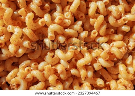 Texture of the homemade elbow macaroni pasta with tomato sauce and stew meat.
