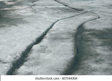 Texture ice surface of a mountain river close up