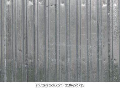 Texture Of Iron Metal Industrial Tin White Sheet Metal Profile With Vertical Boards For The Fence. The Background.