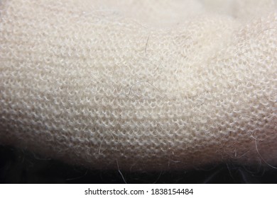 The Texture Of The Knitted Product. Downy Shawl. Fleece. Natural Product. Element Of Clothes.