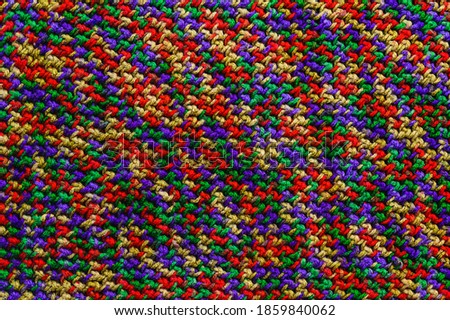 texture of knitted sweater - multi-colored woolen threads close up