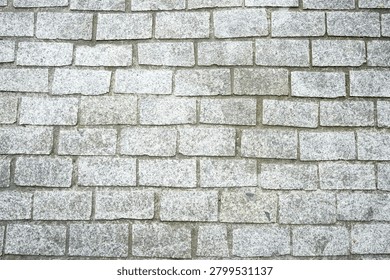 Texture of light gray granite cobblestone pavement
