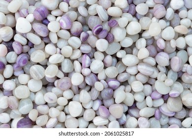 texture of Light Purple lavender plum natural small mineral rock stones gemstone particles. Decorative Stone pebbles for coating in the Aquarium or garden. Extreme close up of heap,  top view 