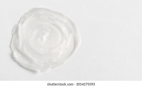 The Texture Of The Lip Balm. Transparent Ointment On A White Background And Copy Space.