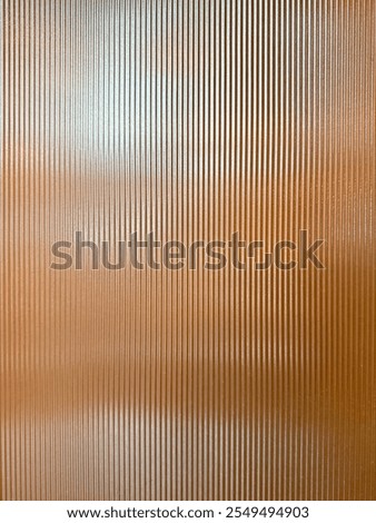 Texture of matt golden bronze fluted glass, or striped glass. Fluted glass is aesthetically beautiful in interior finishes and used for doors and partition. Seamless fluted glass panel.