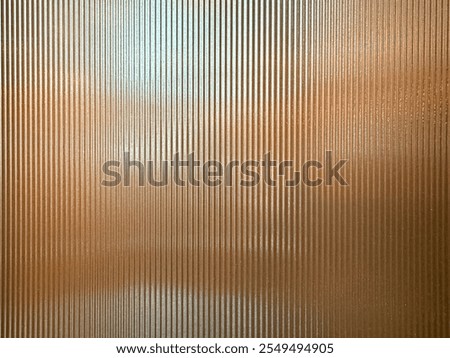 Texture of matt golden bronze fluted glass, or striped glass. Fluted glass is aesthetically beautiful in interior finishes and used for doors and partition. Seamless fluted glass panel.