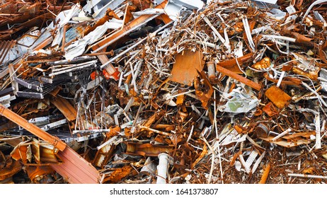 Texture of a metal dump. various forms of rusty metal construction. destroyed metal products on a heap. steel and non-ferrous metal structure