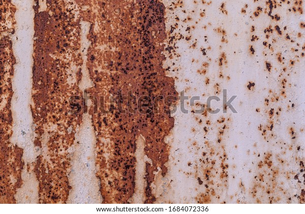 texture: metal wall with white paint and black\
and red rust and\
corrosion