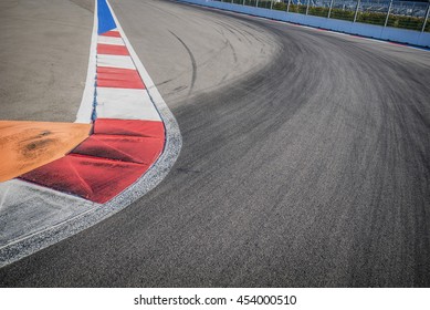 Texture Of Motor Race Asphalt And Red White Curb. Close Up On Grand Prix Street Circuit