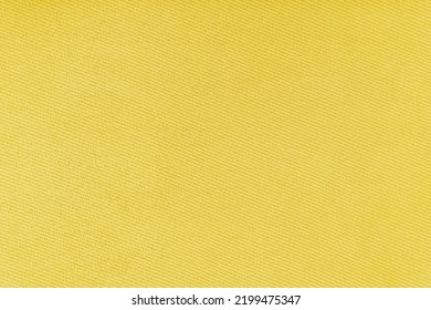 Texture Of Natural Fabric Or Cloth. Fabric Texture Diagonal Weave Of Natural Cotton Or Linen Textile Material. Yellow Canvas Background. Decorative Fabric For Curtain, Furniture, Walls, Clothes