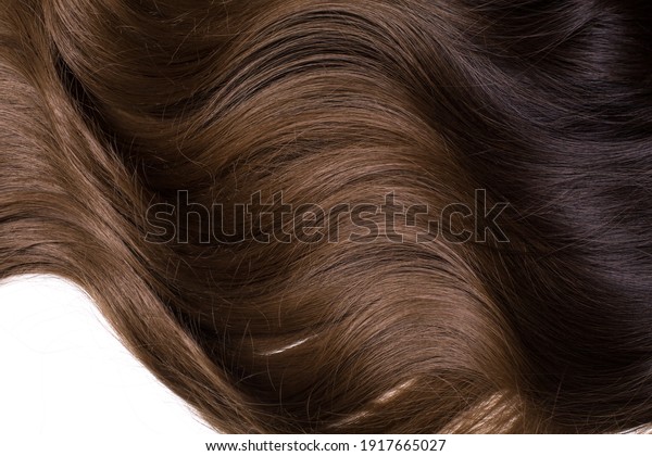 A texture\
of natural looking synthetic dark brown and walnut wavy curly hair,\
cold wave style, isolated on white\
