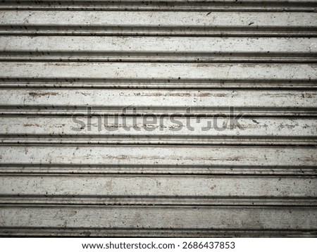 Texture of an old metal rolling shutter door. Backgrounds, textures, or design elements related to urban decay, construction, or street photography themes