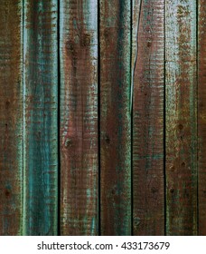 A texture of old painted wooden vertical plank fence  