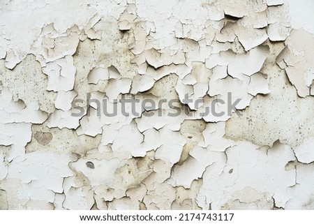 Texture of an old wall with damaged plaster and cracked paint. Abctract background.