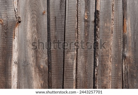 Texture of old weathered unpainted wooden fence
