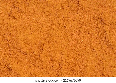 The texture of orange powder. Abstract background of dry dye in full frame.