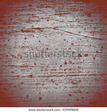 Wall with layers of red, orange and white paint weathered by the sun