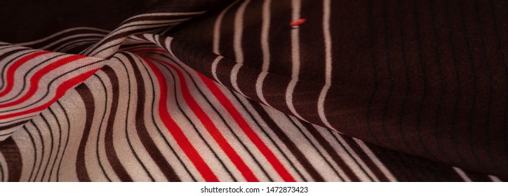 Texture, pattern, collection, silk fabric, brown background with a striped pattern of white and red lines, the Spanish theme, which is great for the design of procedures and projects.