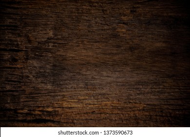 Texture and pattern of old dark brown wood.Old wood concept in vintage tone 