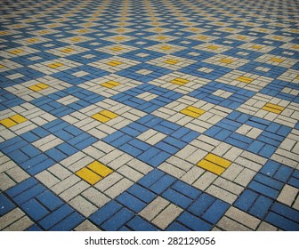 The texture of perspective colored checkered tile in the street