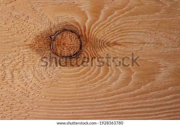 The texture of a pine board\
with a knot in the middle, after mechanical processing. Background\
image