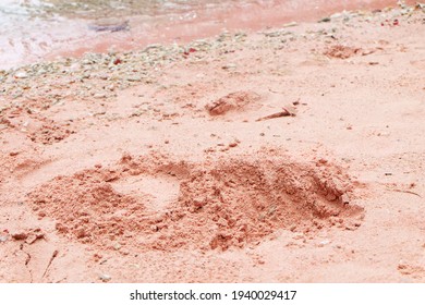 The texture of pink sand on the beach in the afternoon