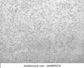 The texture of the plaster is bark beetle on the wall. Seamless grey texture.