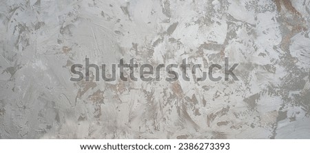 The texture of the plaster on the wall, rough strokes made with a palette knife, paint on the surface, abstract background for design