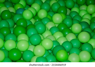 Texture Of Plastic Balls For Children. Background Of Green Balloons. Pile Of Toy Balls For Dry Pool