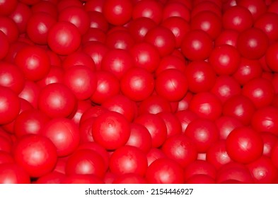 Texture Of Plastic Balls For Children. Background Of Red Balloons. Pile Of Toy Balls For Dry Pool