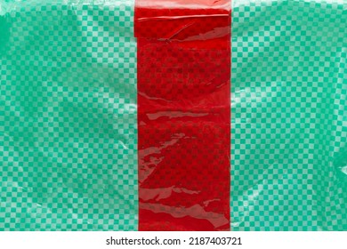 Texture Of A Plastic Package With A Strip Of Red Protective Tape. Sending Parcels With Protection Against Opening And Theft