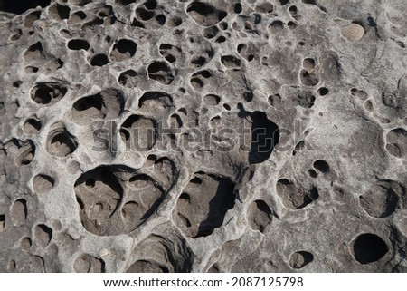 texture of porous stones on the beach, nature, natural phenomena, brown-gray stones